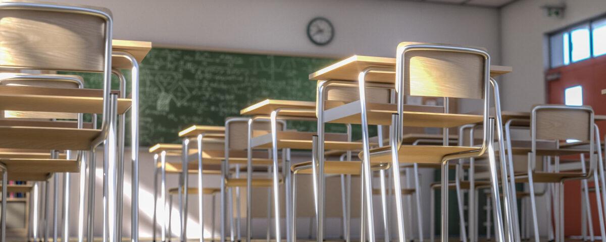 interior of a traditional style school with chairs and wooden desks