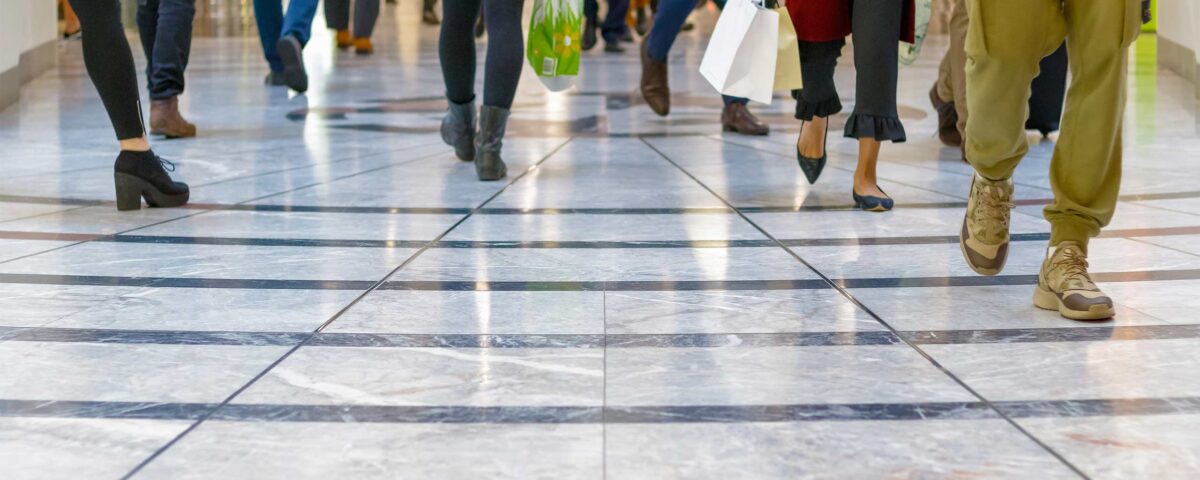 A modern floor with legs of a crowd in the background
