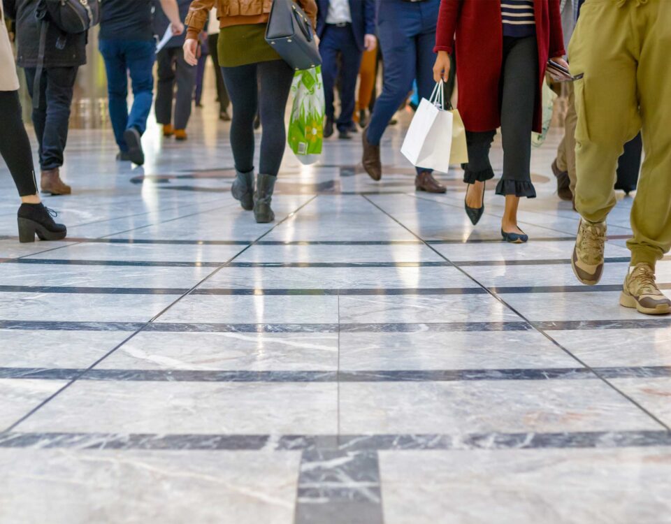 A modern floor with legs of a crowd in the background