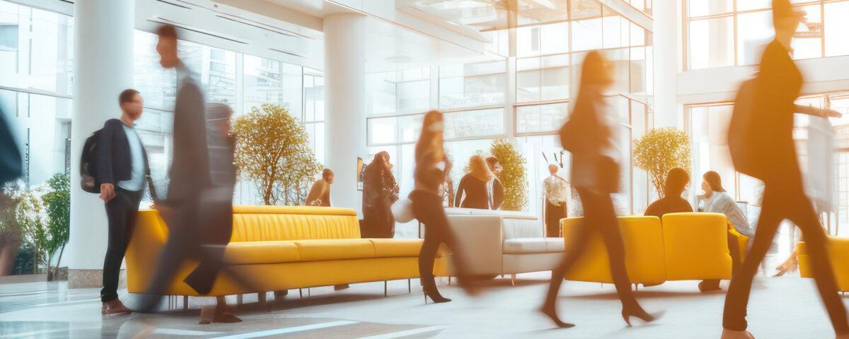 Bright business workplace with people in walking in blurred motion in modern office space