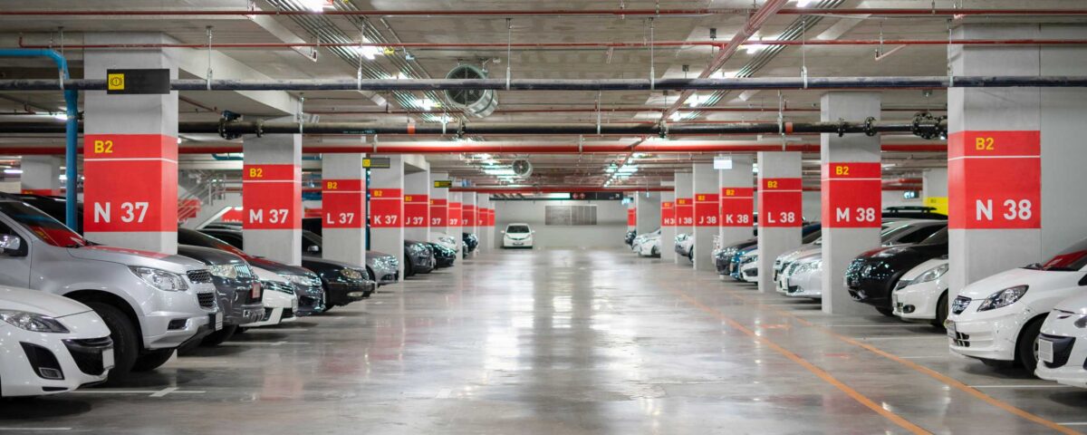Blurred Parking garage interior shot of multi-story car park, underground parking with cars.