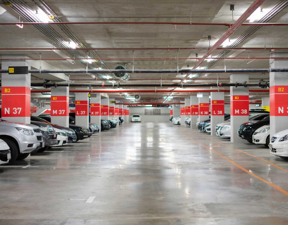 Blurred Parking garage interior shot of multi-story car park, underground parking with cars.